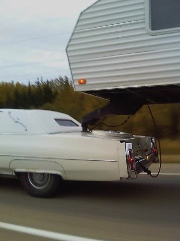 Cadillac towing a fifth wheel trailer
